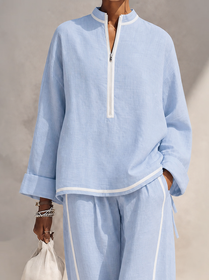 Close-up of the stand collar and half-zip front on the light blue linen top