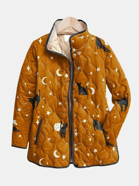 Winifred quilted jacket shown flat: cats, moons and stars on warm ochre with a gold-tone snap front