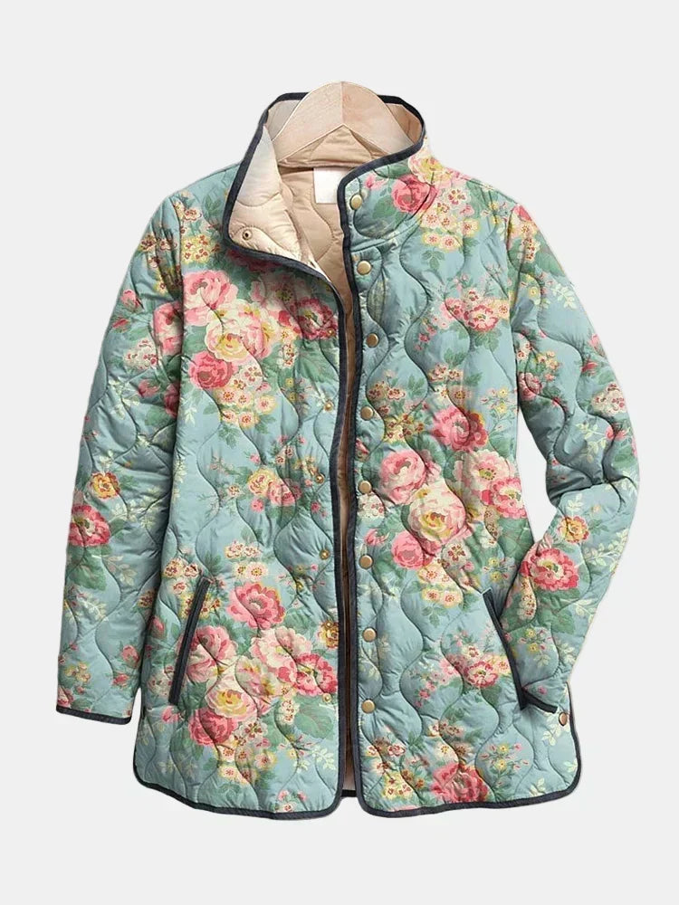 Adelaide quilted jacket shown flat: pink and cream roses on soft celadon with curved quilting and dark piping