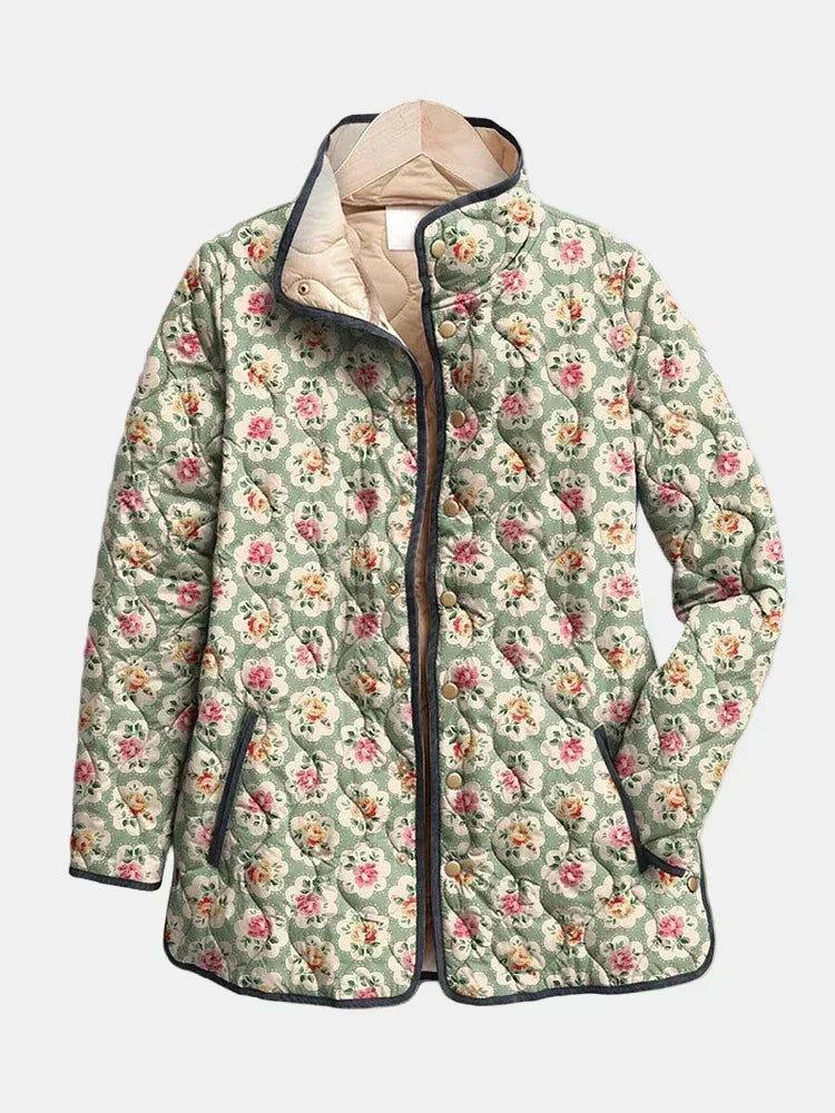 Seraphine quilted jacket shown flat: small roses on almond green, dark piping, stand collar with cream lining