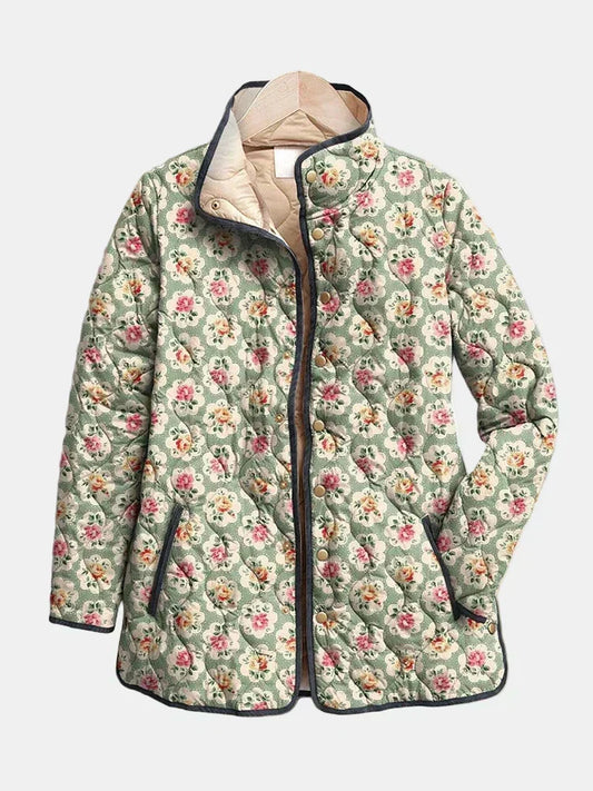 Seraphine quilted jacket shown flat: small roses on almond green, dark piping, stand collar with cream lining