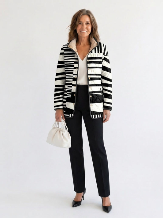 Woman wearing the Constance quilted graphic stripe jacket open over an ivory top with black trousers