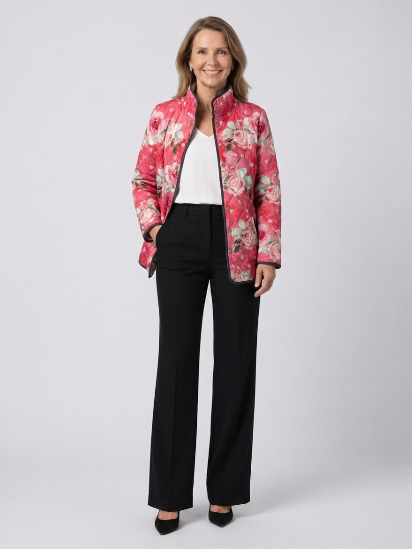 Woman wearing the Cordelia quilted dusty rose jacket open over an ivory top with black trousers