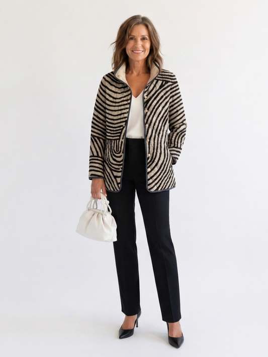 Woman wearing the Harriet quilted hand-drawn circle jacket open over an ivory top with black trousers