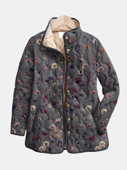 Dorothea quilted jacket shown flat: mauve and plum dried flowers on warm gray with a gold-tone snap front