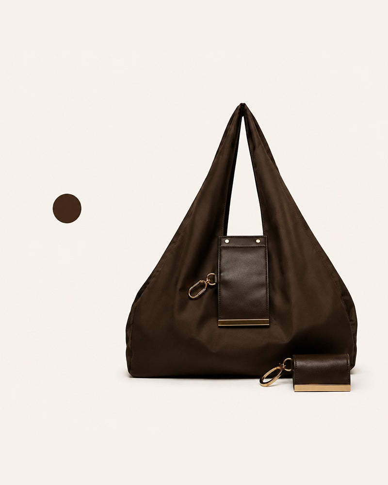 Varelli vegan leather tote bag shown folded as a charm and fully opened