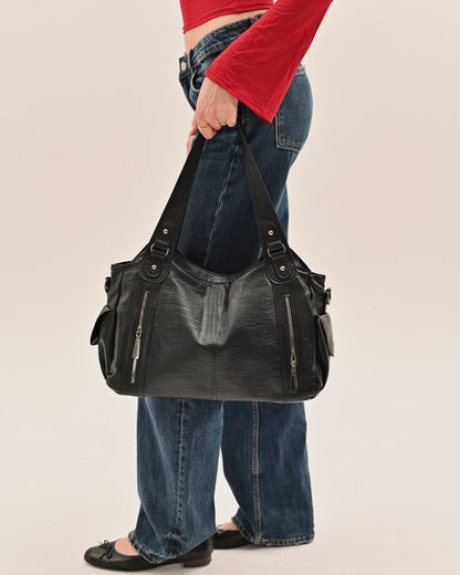 Side view of the Edyisa black vegan leather shoulder bag