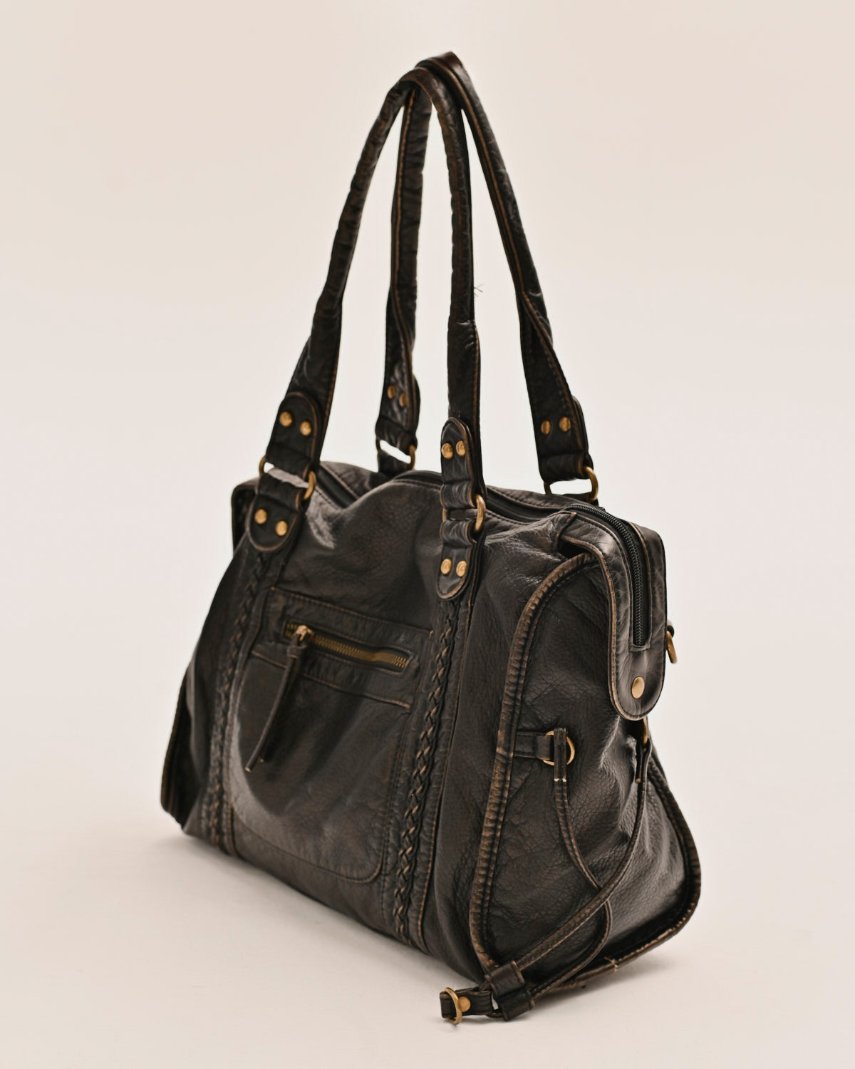 Close-up of the antique gold hardware on the Edyisa black leather city bag