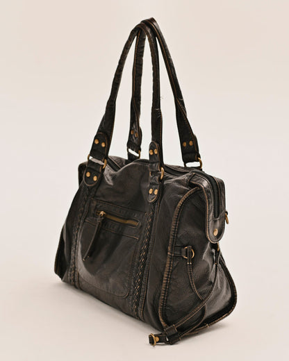 Close-up of the antique gold hardware on the Edyisa black leather city bag