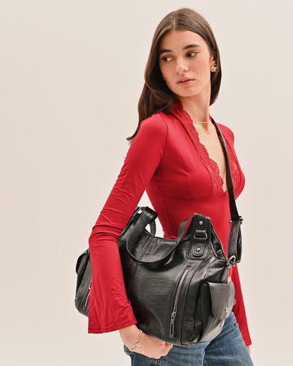 Woman carrying the Edyisa black shoulder bag over one shoulder