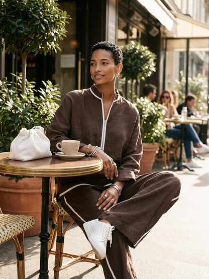 Brown linen blend half-zip top and wide-leg pants set at a cafe table