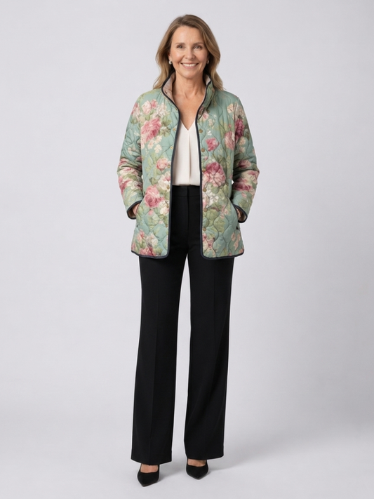 Woman wearing the Rosemary quilted vintage rose jacket open over an ivory top with black trousers