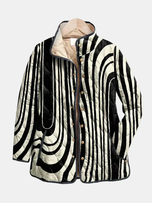 Philippa quilted jacket shown flat: black and white hand-drawn zebra curves with dark piping and stand collar