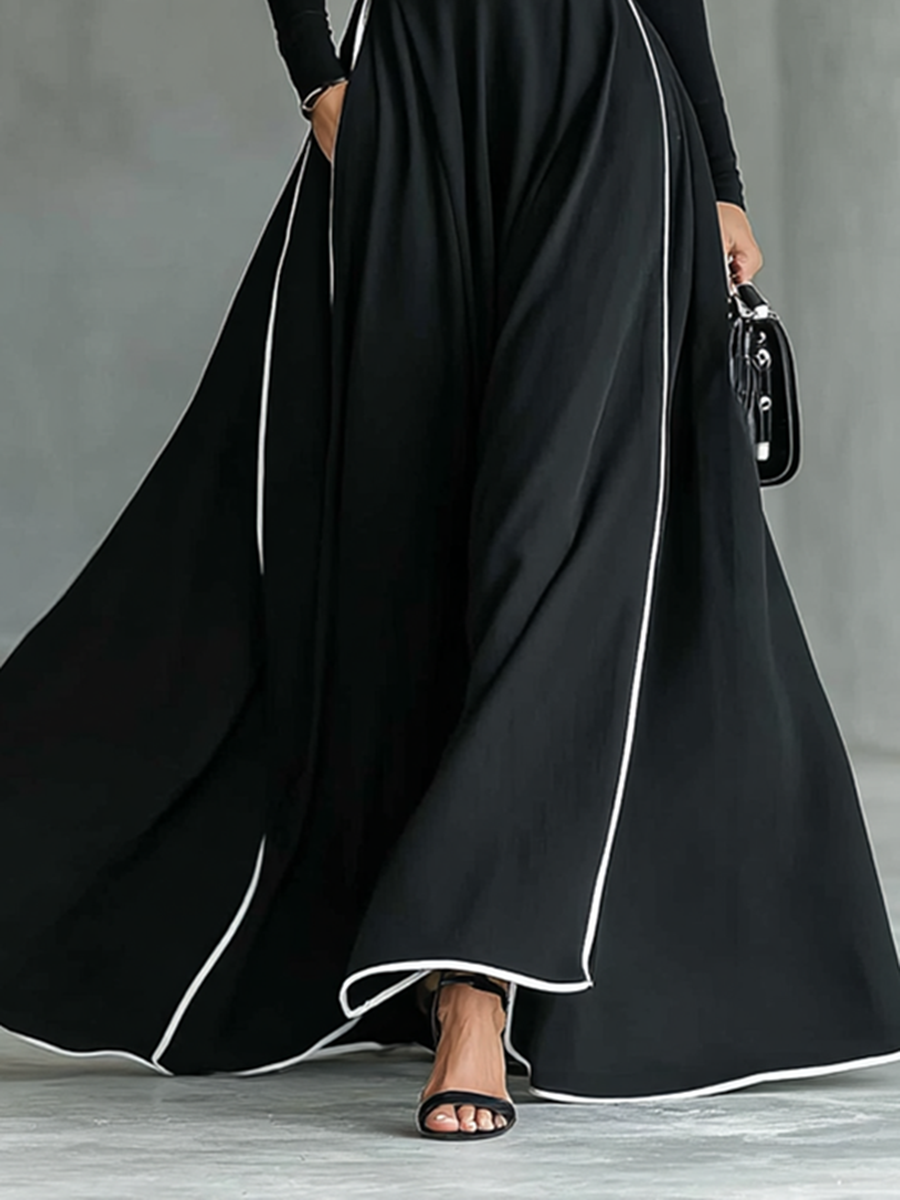 Detail of the full skirt and white piped hem of the Odette maxi dress