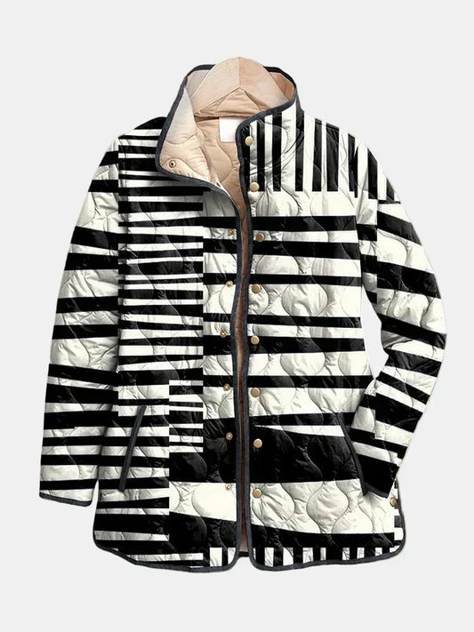 Constance quilted jacket shown flat: black and white block stripes running in different directions, gold-tone snap front and dark piping