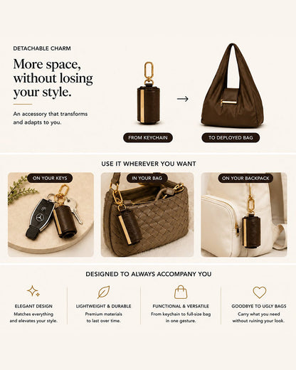 Varelli charm clipped onto a handbag next to the unfolded vegan leather tote