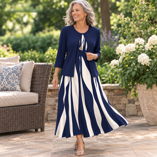 Woman walking outdoors in the Elyne Elegant Two-Piece Dress Set in navy blue, with the jacket open over the wave-print maxi dress